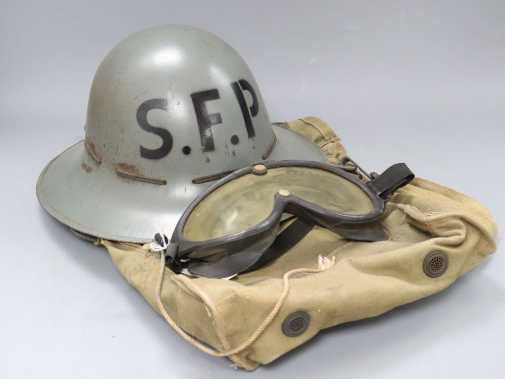 A World War II Zuckermann civil defence helmet, a case and goggles